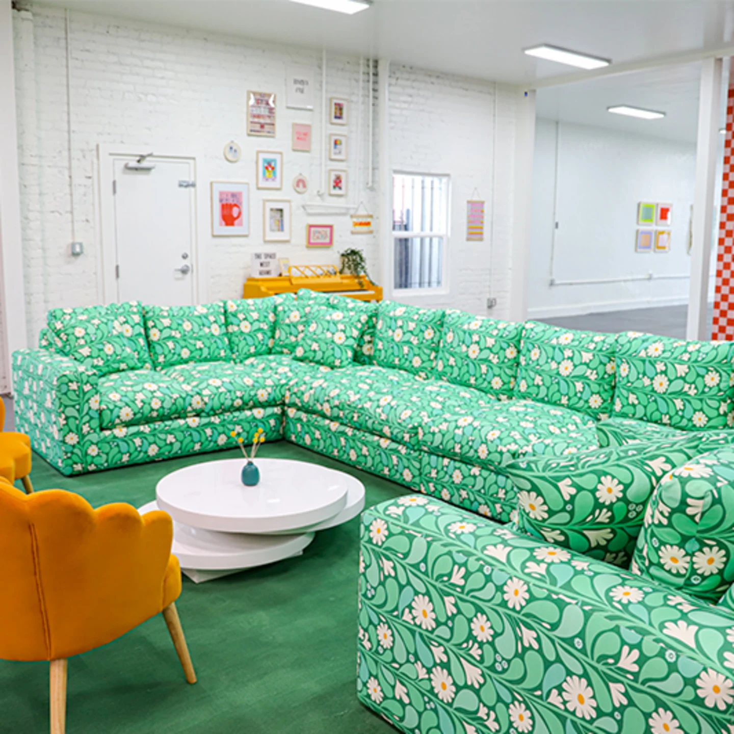 Mint green floral sectional couch in a Space Camp Organizing workspace.