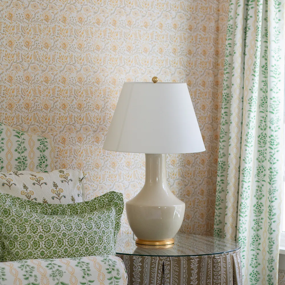 Guest bedroom with yellow floral wallpaper.