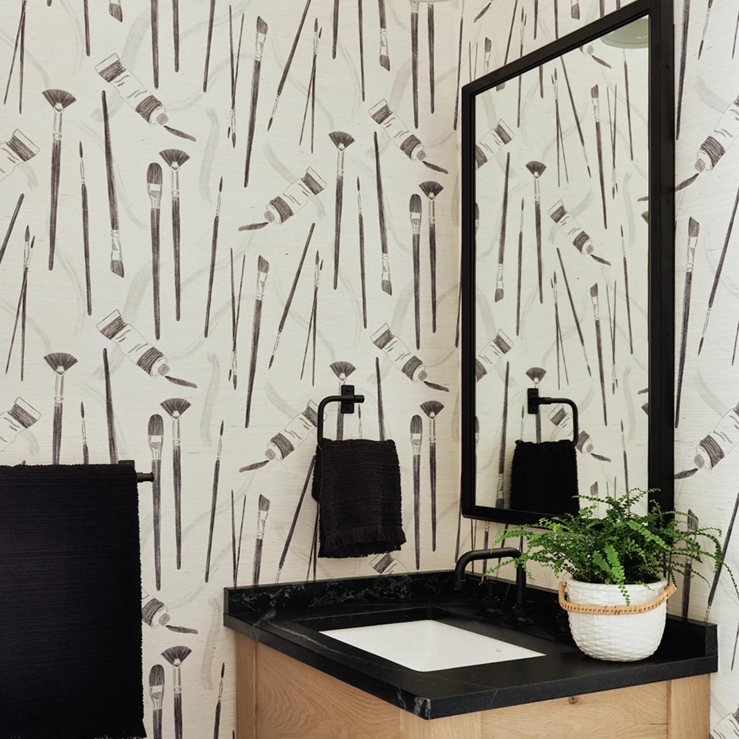 Bathroom with black and white paint tool design grasscloth wallpaper.