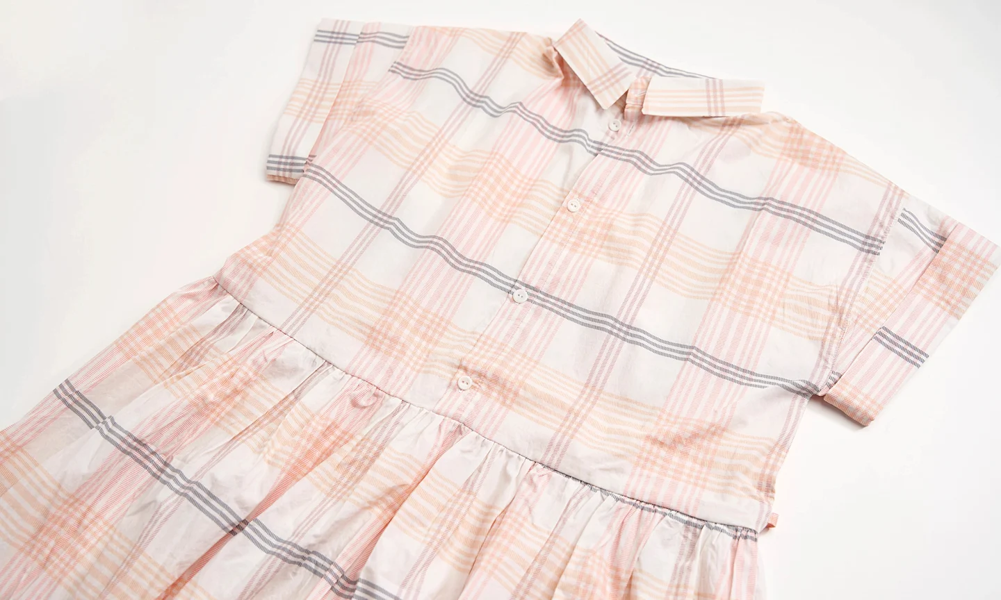 Plaid dress laying out.