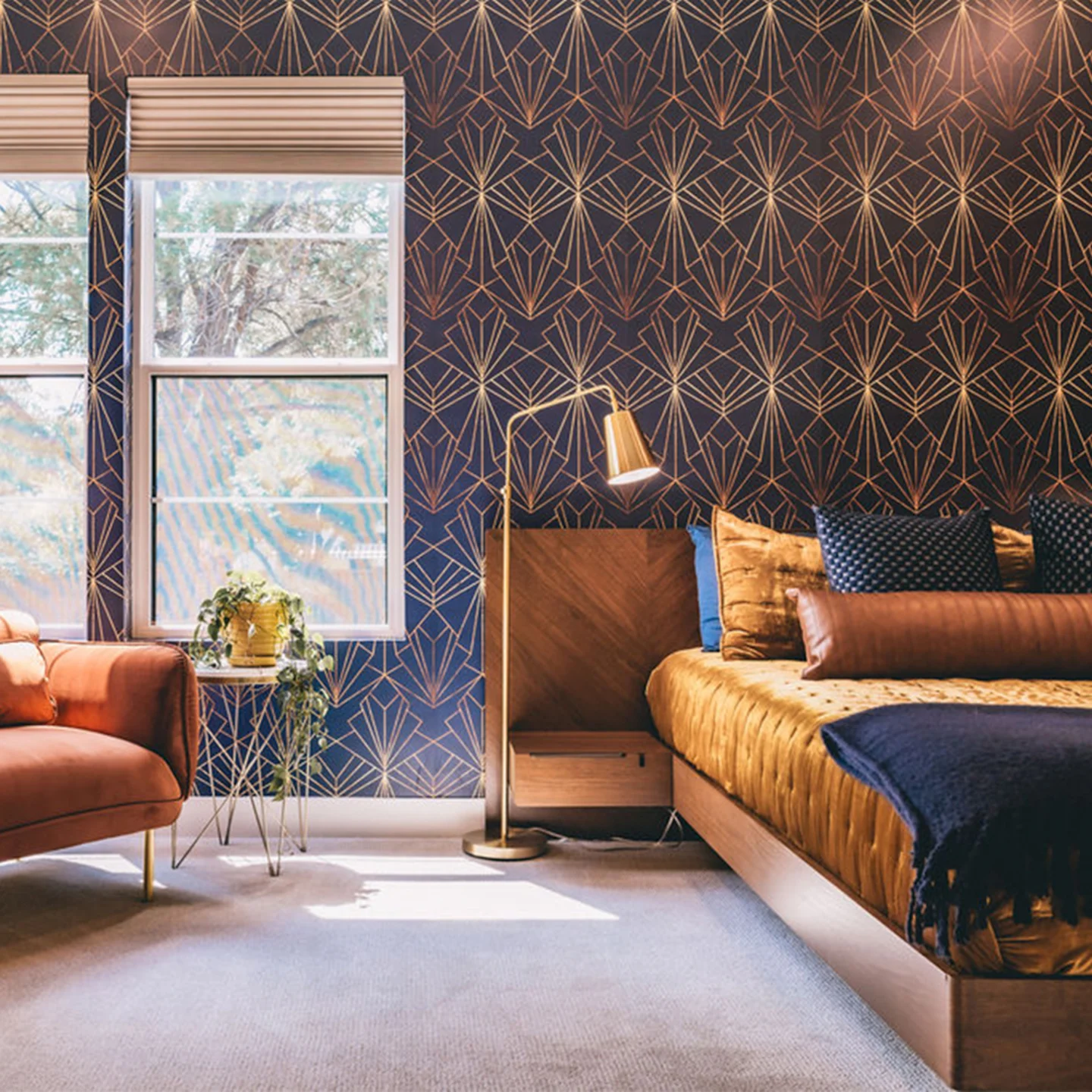 Bedroom with navy and gold geometric wallpaper