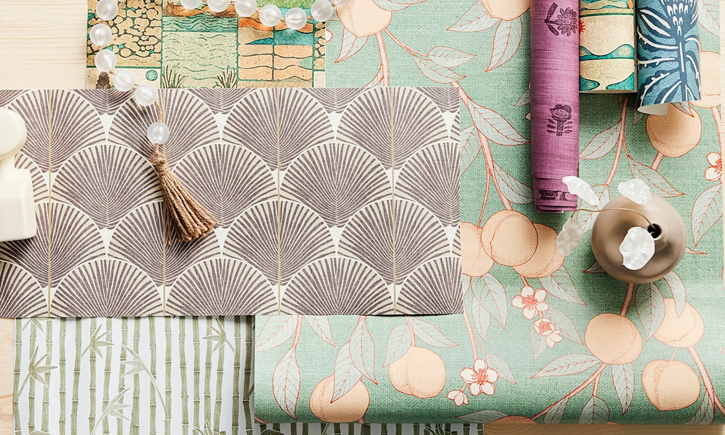 Japandi designed wallpaper rolls styled together.