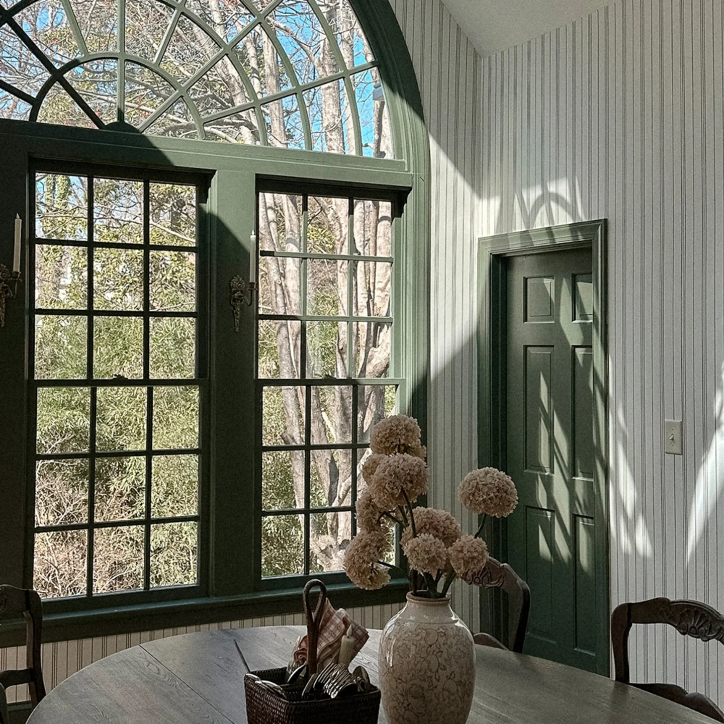 Dining room with striped wallpaper.