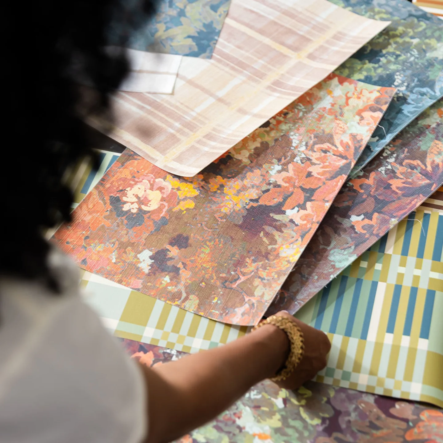 Person looking at wallpaper swatches