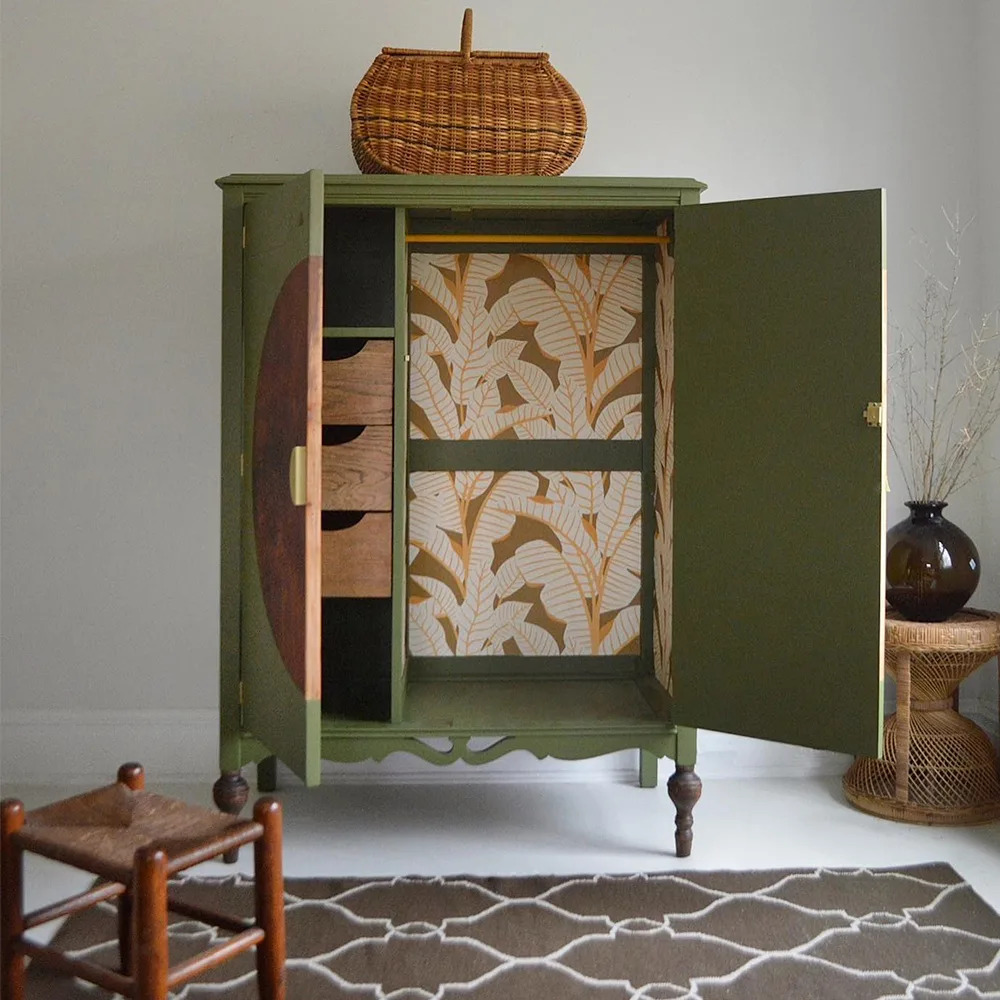 Golden yellow and green palm wallpaper in a green wardrobe.