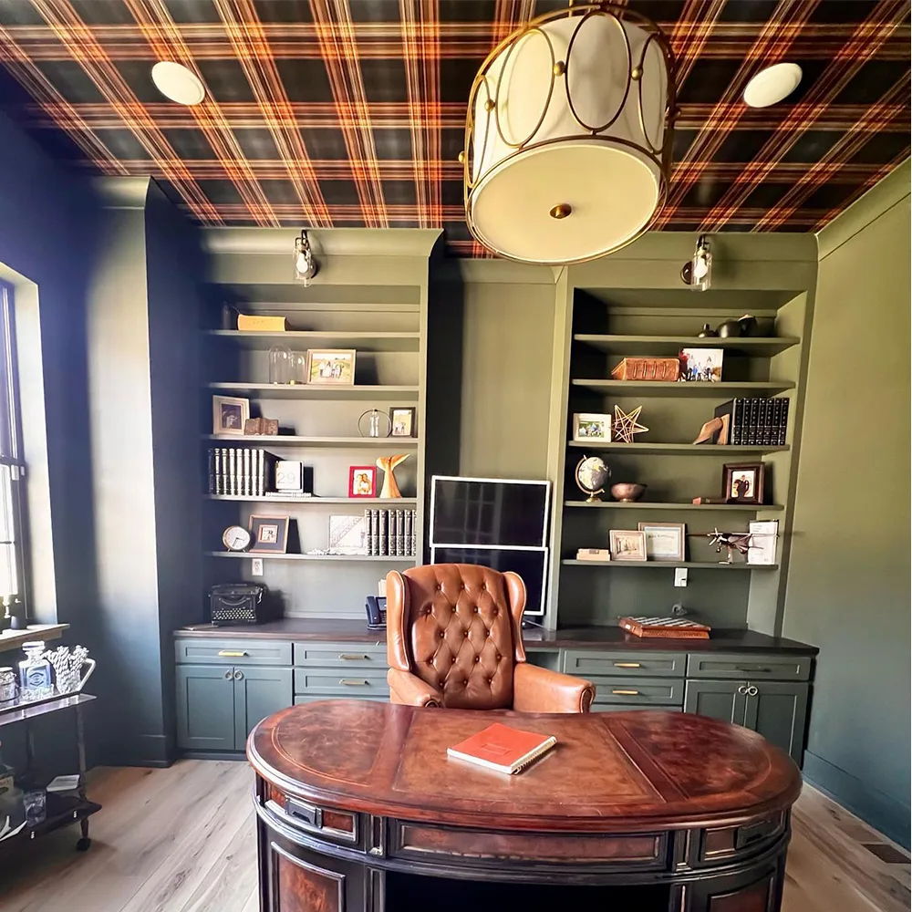 Plaid wallpaper on a ceiling of a home office.