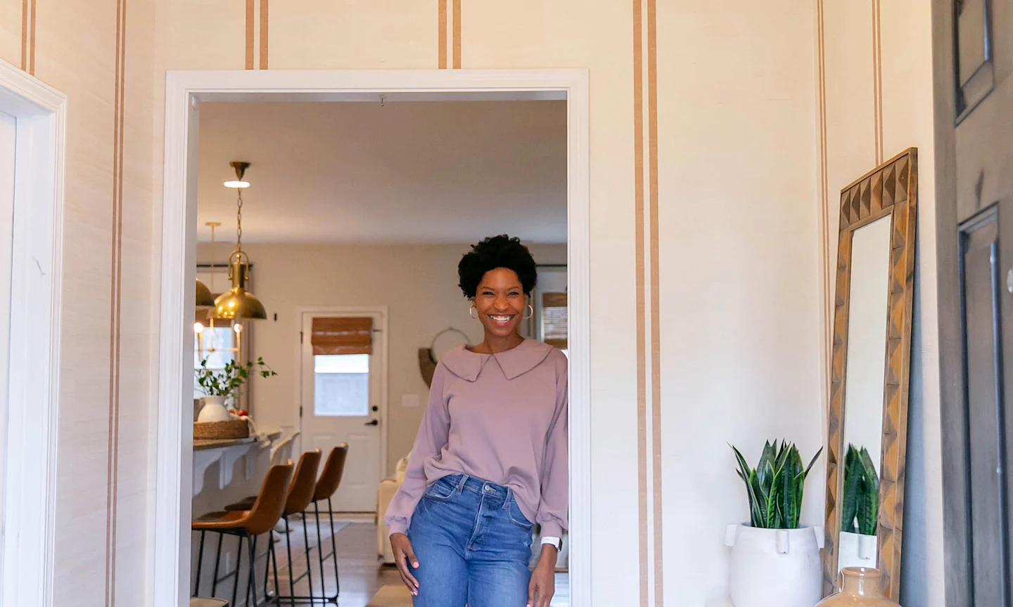 Tiffany of the Prettyreal blog in her entryway redone with grasscloth wallpaper.