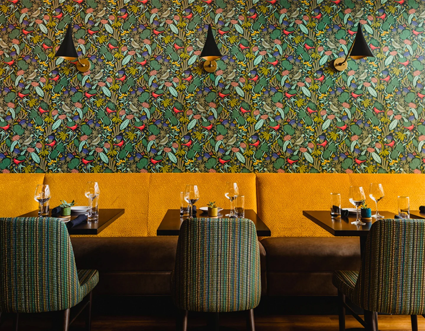 Wallpaper hanging above a restaurant booth.